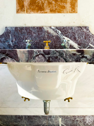 Lynnewood Hall Chamber C Bathroom, stunning purple and white veined marble sink with gold plated fixtures used by guests of the Widener Family.