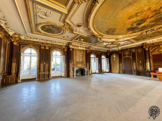 Lynnewood Hall Ballroom, large French influenced room used for gatherings and celebration with the ability to hold 1000 guests. Ceiling is high style, featuring faces and figures with rich gilding and dark oak paneled walls.